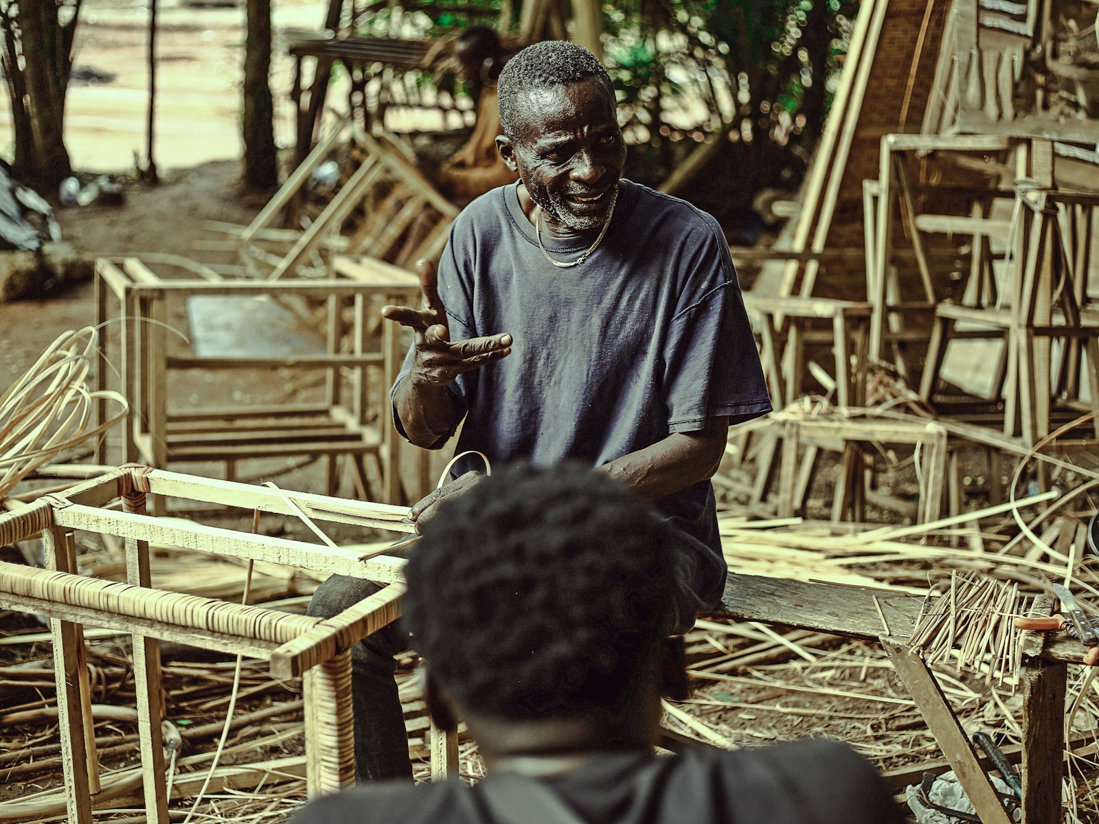 Craftsman checking his phone in his furniture workshop