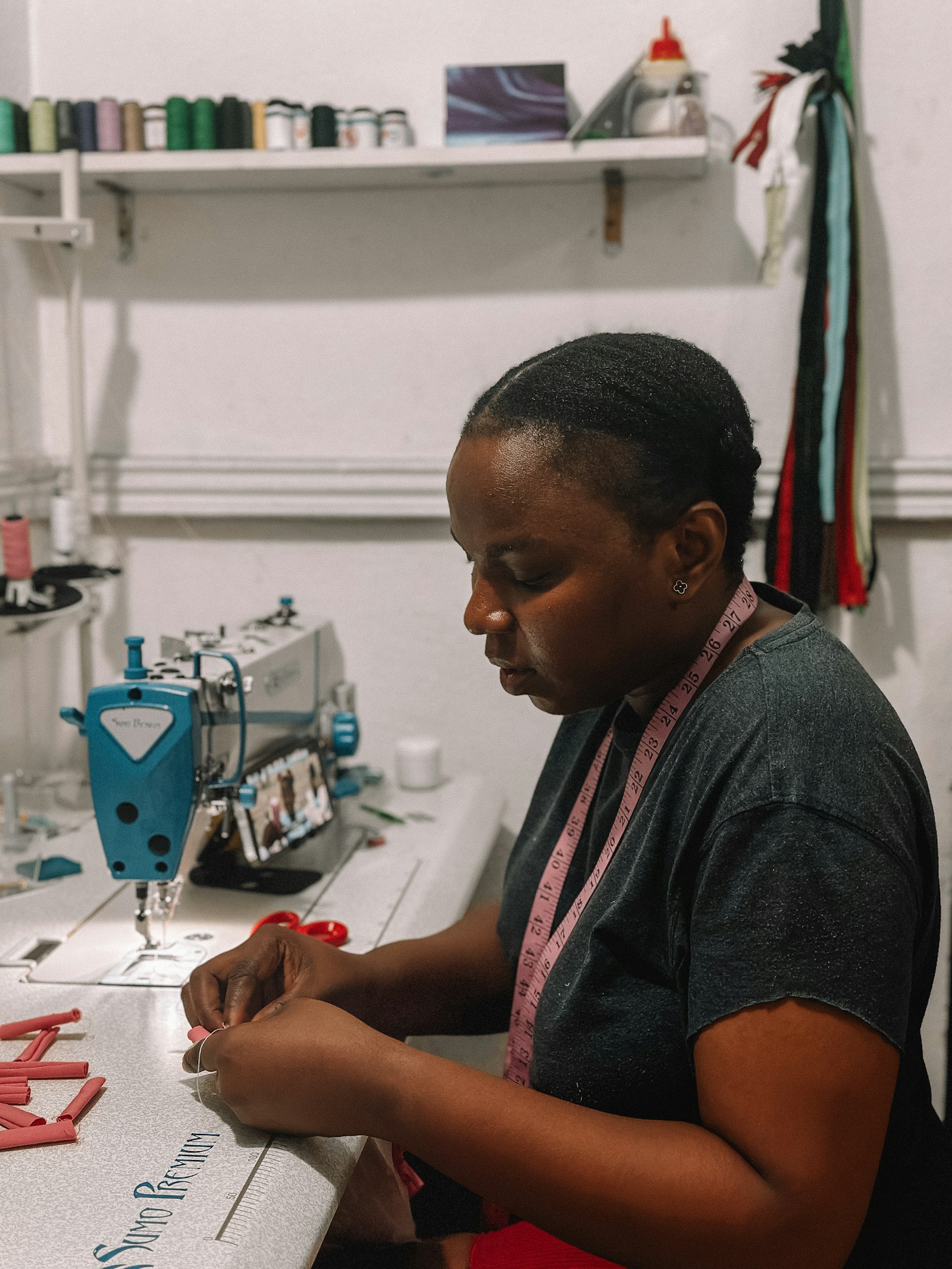 Fashion designer sewing a new piece in her workshop